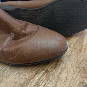 Women short Brown Leather Shoes. Zips on the inside of boot. Two black spots .
